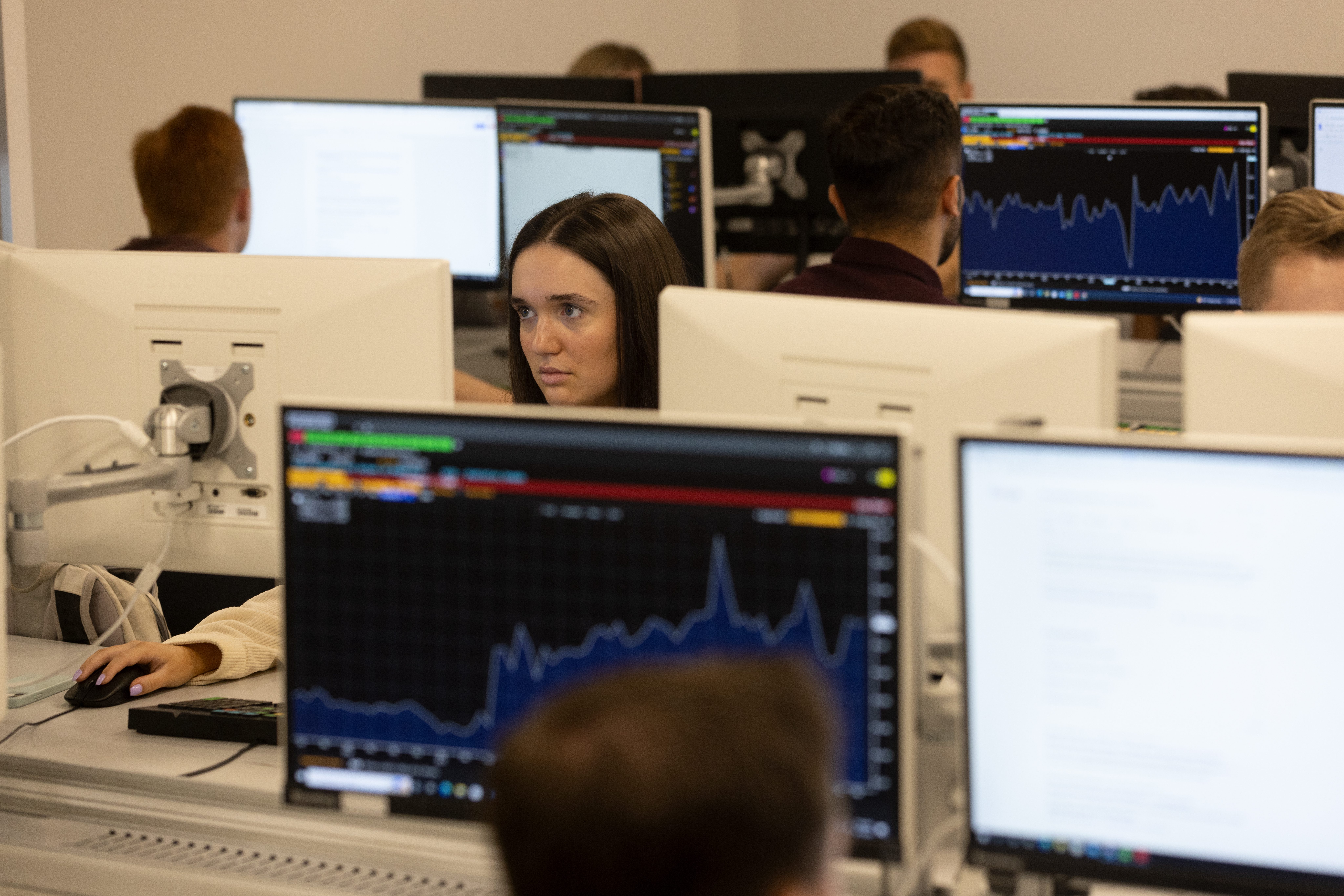 Students in the the Bloomberg lab sitting at desks and working on computers.