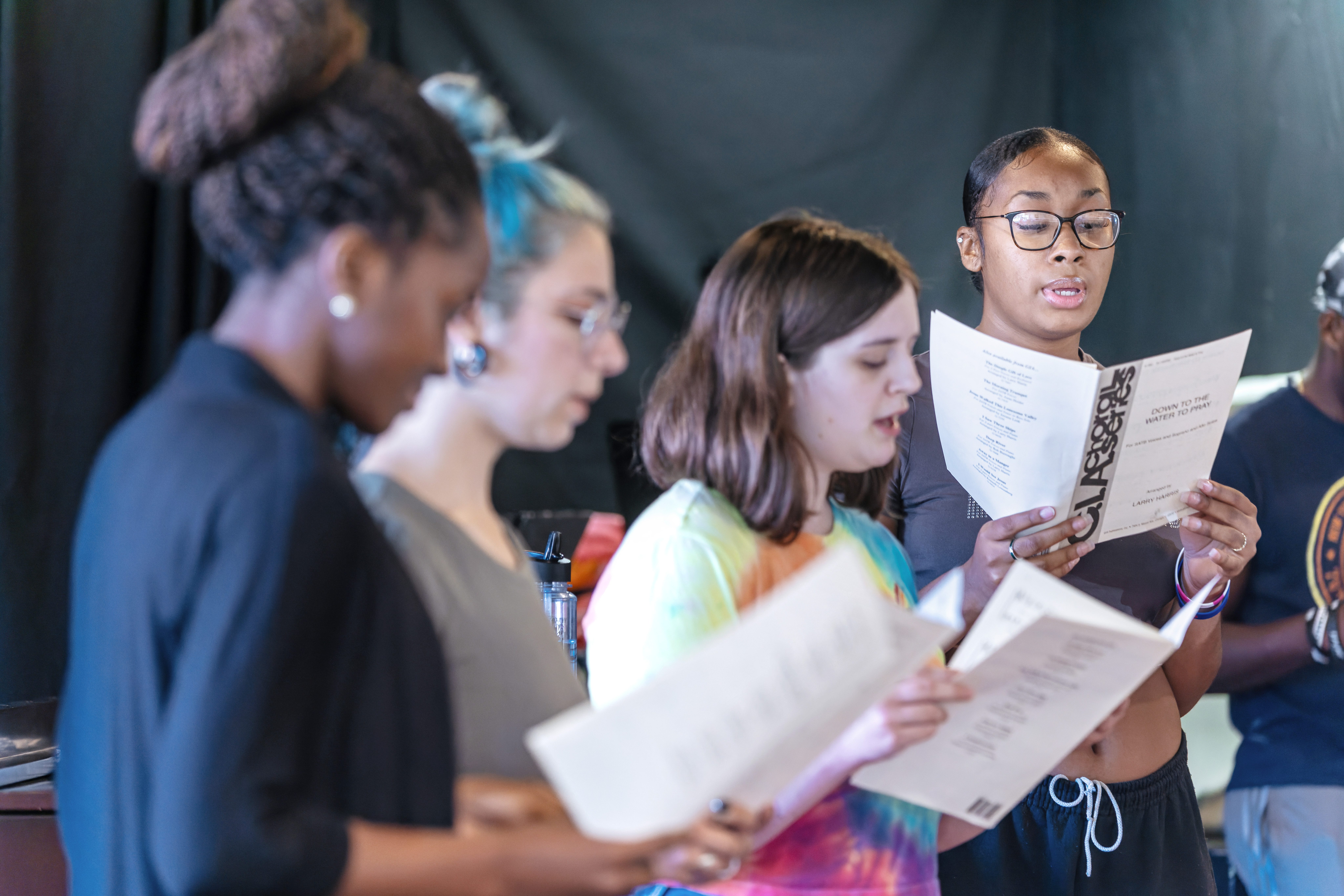 Students in the Sullivan Theater reading a script.