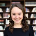 Student in front of Book shelf