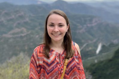 Student on top of a mountain