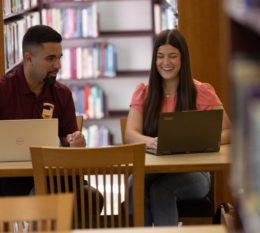 2 students studying in the library