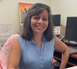 Faculty Portrait at desk inside