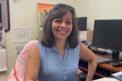 Faculty Portrait at desk inside