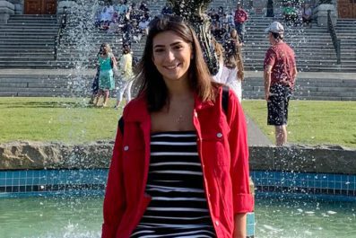 Student in front of a fountain