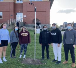 Six Students with weather station in front of Costello Hall