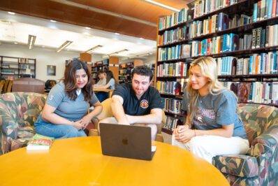 students chatting in library