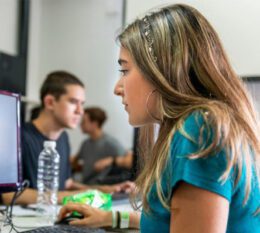 Student seated at computer looking at monitor