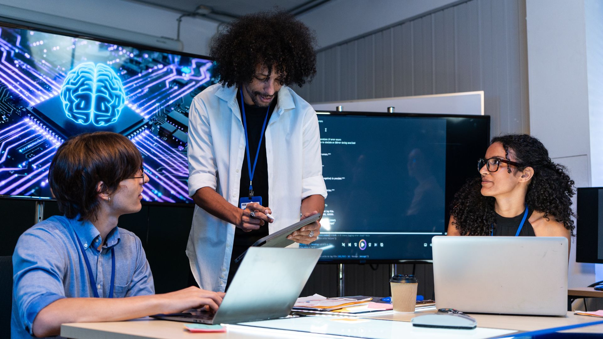 people discussing work at computers