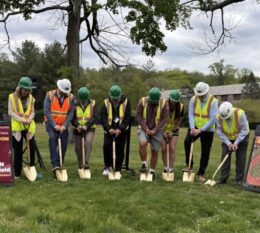 track groundbreaking with 8 individuals from LandTek, the Town, and College administration and students shoveling into the ground wearing hard hats and vests