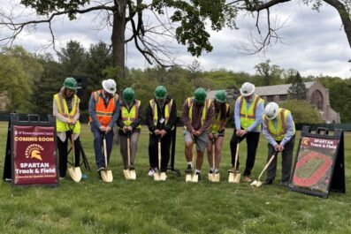 track groundbreaking with 8 individuals from LandTek, the Town, and College administration and students shoveling into the ground wearing hard hats and vests