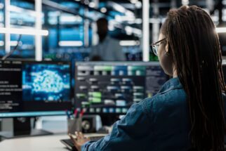 woman working at cybersecurity monitoring station