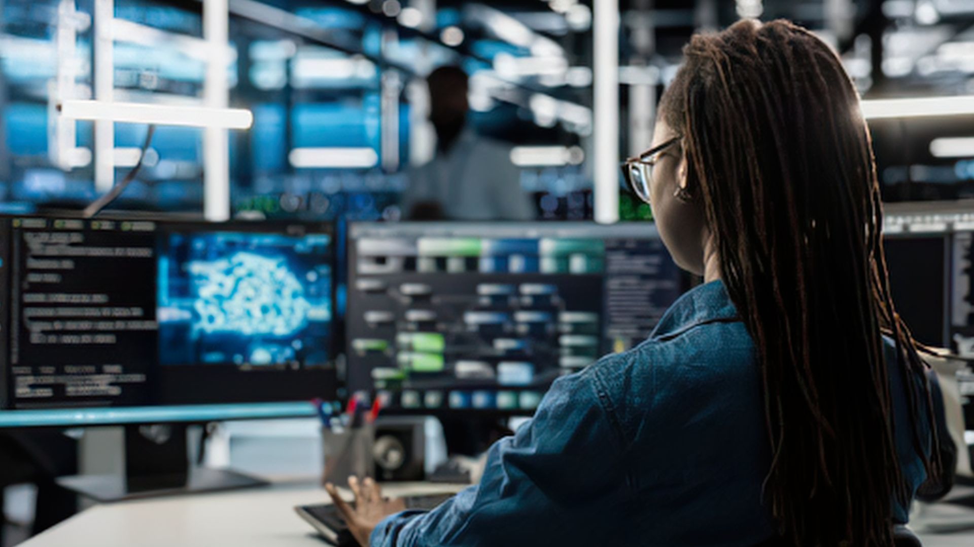 woman working at cybersecurity monitoring station
