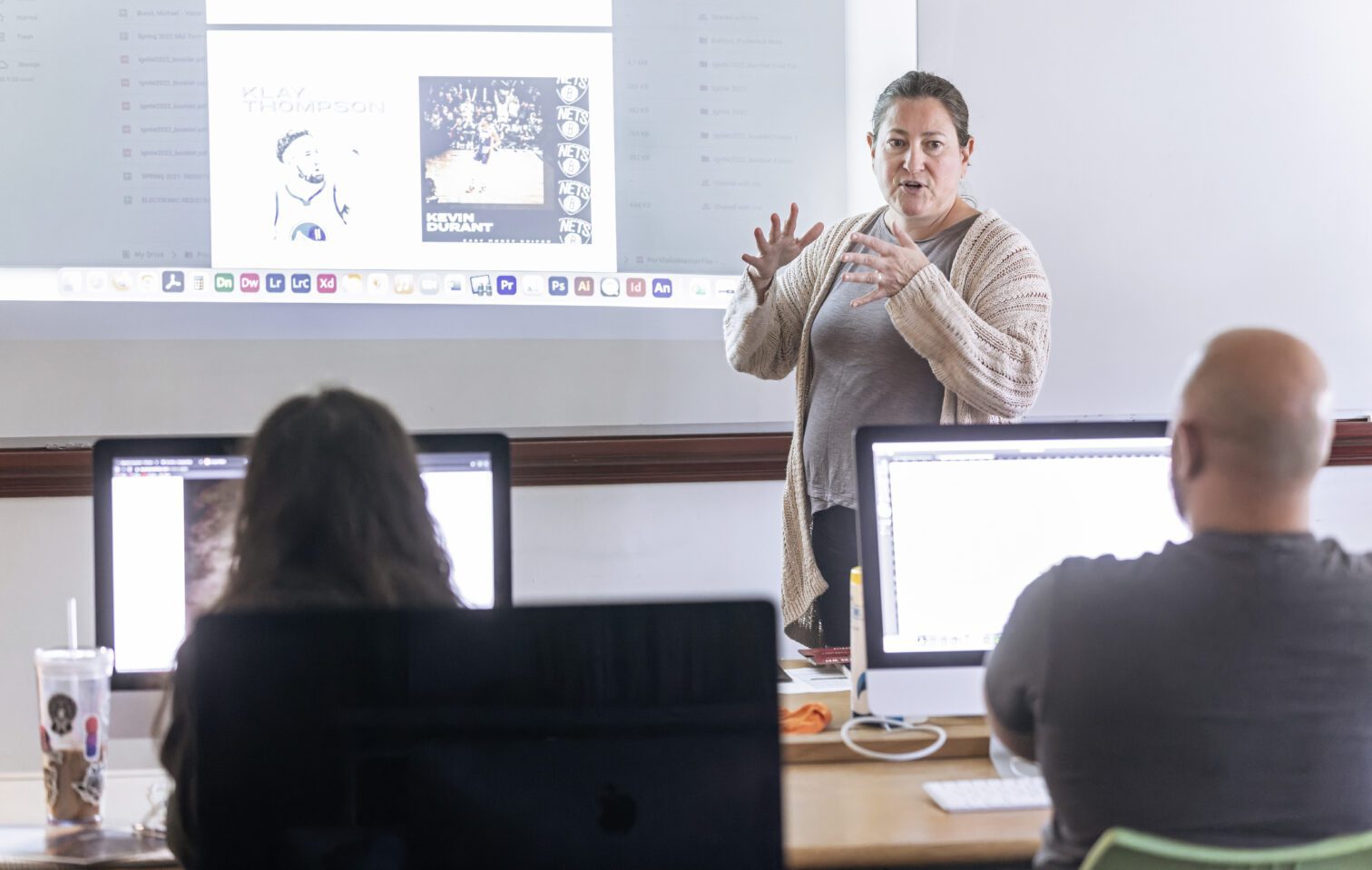 Professor teaching in class, talking to students in a computer lab