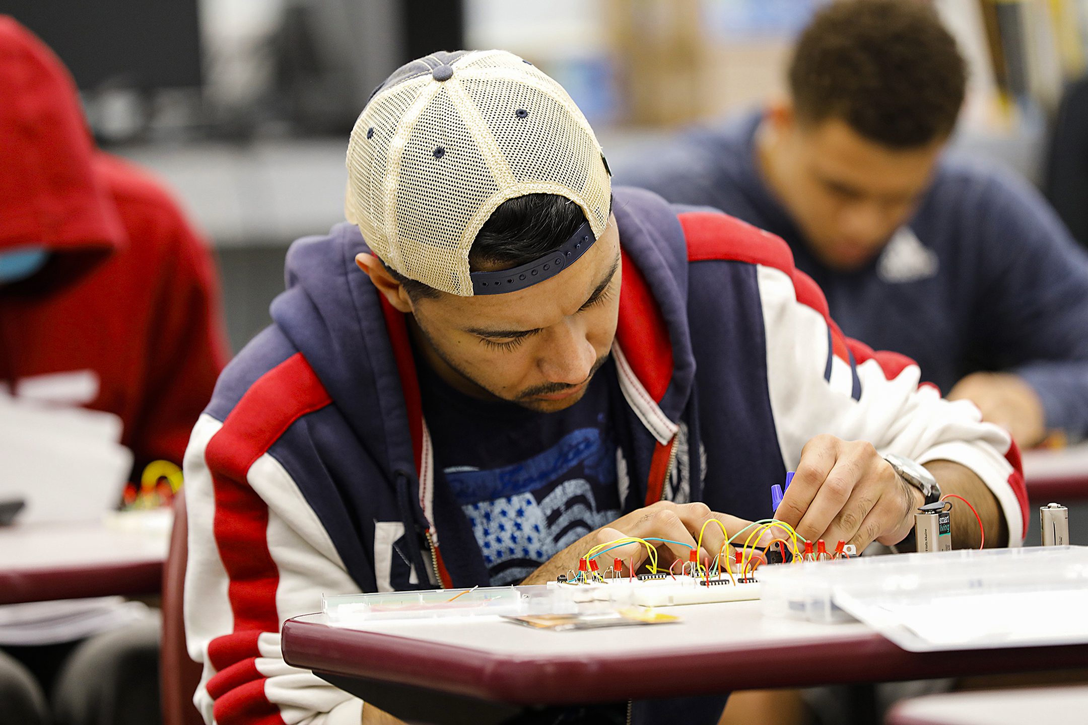 male student working on circuit board wiring